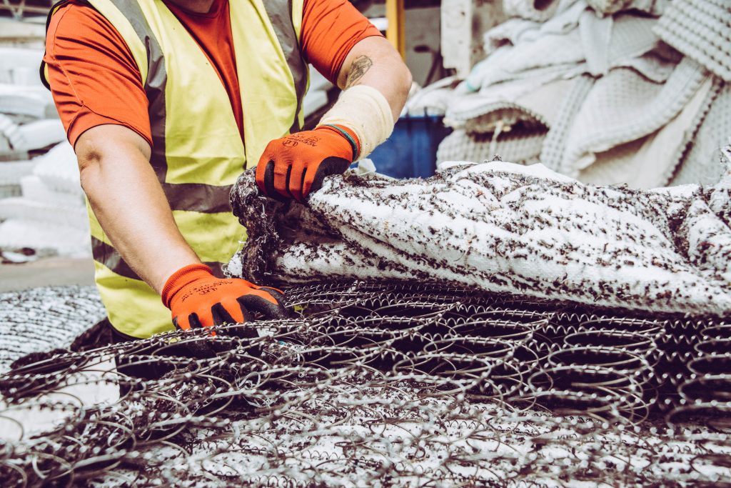 job picking up returned mattresses in a box